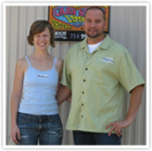 Owners standing in front of Orion Automotive sign